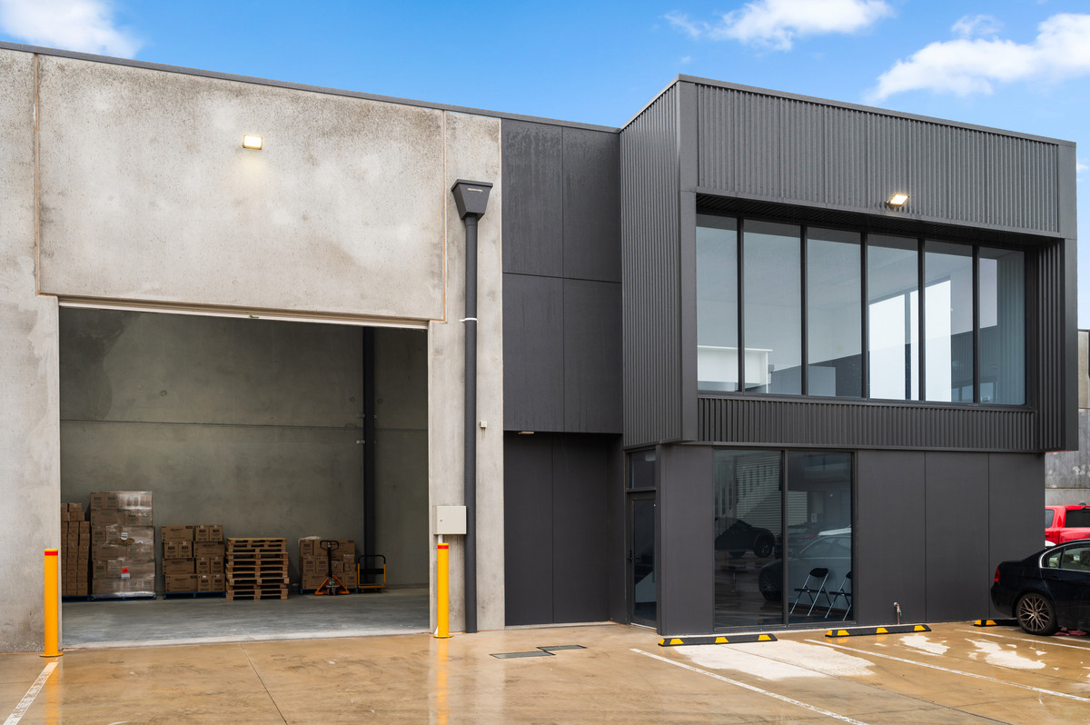Front exterior with roller door open to the warehouse